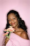 African-American woman holding flowers.