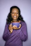 African-American woman holding latte cup.