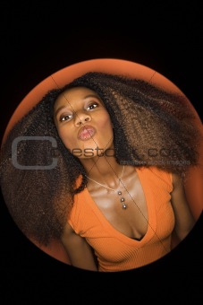 Young African-American woman puckering her lips.