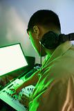 Male DJ using mixing equipment.