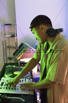 Male DJ with hands on turntable. 