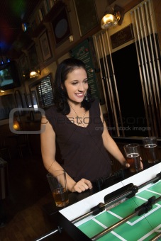 Young woman playing foosball.