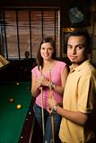 Young couple at pool table.