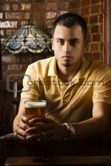Young man holding beer.