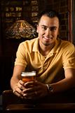 Portrait of young man holding beer.