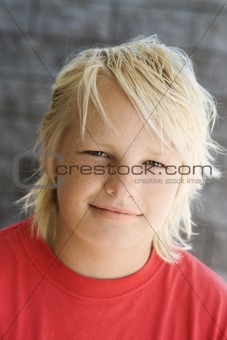 Teen blonde boy smiling.