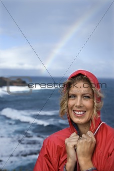 Woman by ocean and rainbow in Maui, Hawaii.