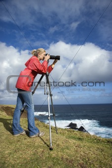 Woman photographing scenery in Maui, Hawaii.