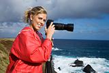 Woman photographing scenery in Maui, Hawaii.