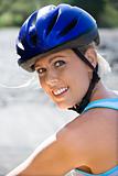 Young woman bicycling.