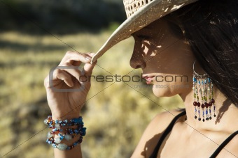 Young woman tipping a cowboy hat.