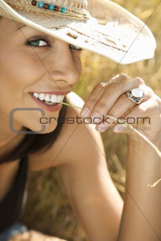 Young woman in straw cowboy hat.