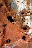Old rusty metal with holes.