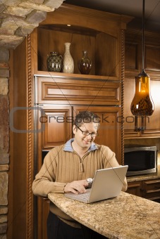 Mid-adult male working on computer.