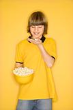Caucasian boy with bowl of popcorn. 