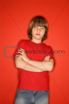 Caucasian boy with arms crossed.