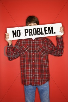Caucasian teen boy holding no problem sign.