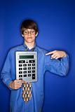 Caucasian teen boy pointing to calculator.