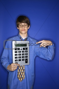 Caucasian teen boy pointing to calculator.