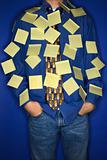 Caucasian teen boy covered with sticky notes.