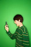 Caucasian teen boy screaming at cellphone.