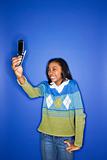 African-American teen girl with camera phone.