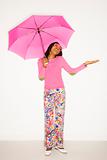 African-American teen girl holding pink umbrella. 