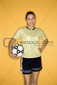 Multi-racial teen girl holding soccer ball.