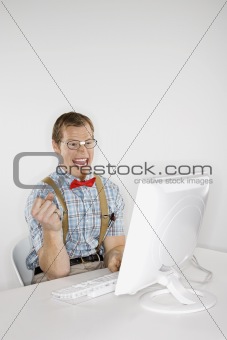Young man looking at computer monitor.
