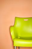 Green chair against wall.