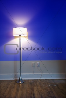 Lamp against blue wall.