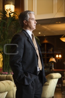 Businessman standing in hotel lobby.