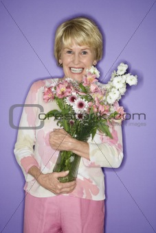 Woman holding flower bouquet.