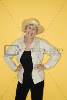 Woman with hands on hips smiling.