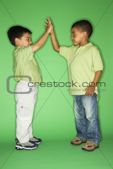 Boys giving each other high five.