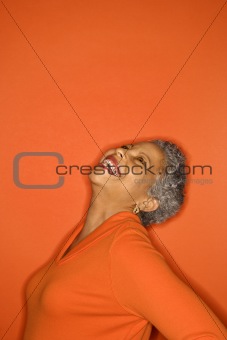 Woman with head back smiling.