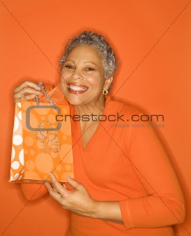Woman holding gift bag.