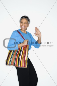 Woman holding big purse.