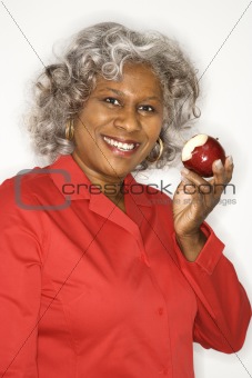 Woman holding half eaten apple.