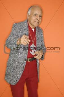 Man wearing money sign necklace and pointing.