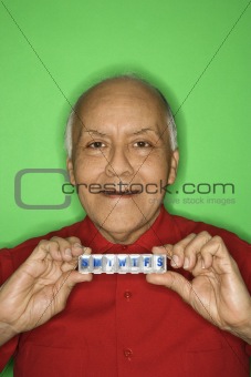 Man holding pill organizer.