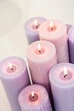 Close up of lit lavendar candles.