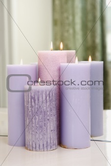 Group of purple candles burning.