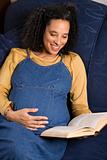 Pregnant female reading a book.