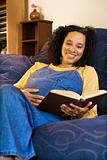 Pregnant female reading a book.