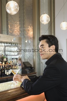 Adult male sitting at bar.