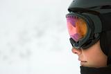 Boy skier wearing goggles and helmet.