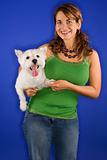 Woman holding white terrier dog.