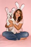 Woman and dog wearing rabbit ears.