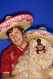 Dog and man wearing  sombreros.